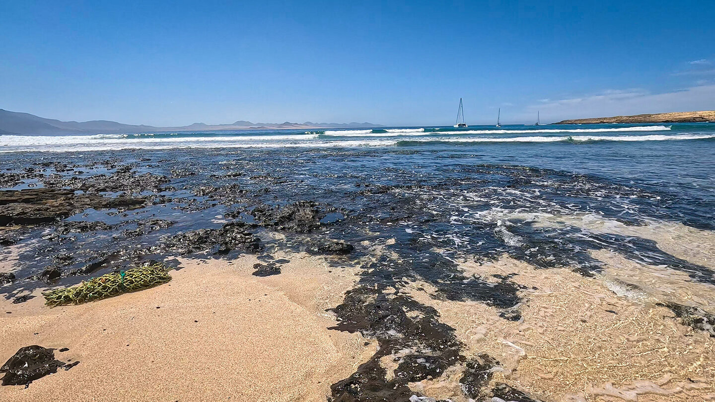 vom Strand Playa Francesa blickt man zu den Vulkanen des Timanfaya auf Lanzarote